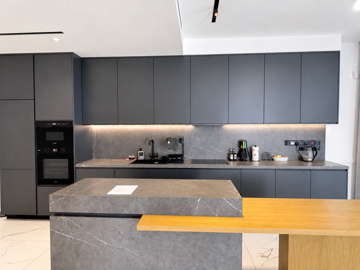 Open-plan kitchen with island in the deluxe one-bedroom apartment