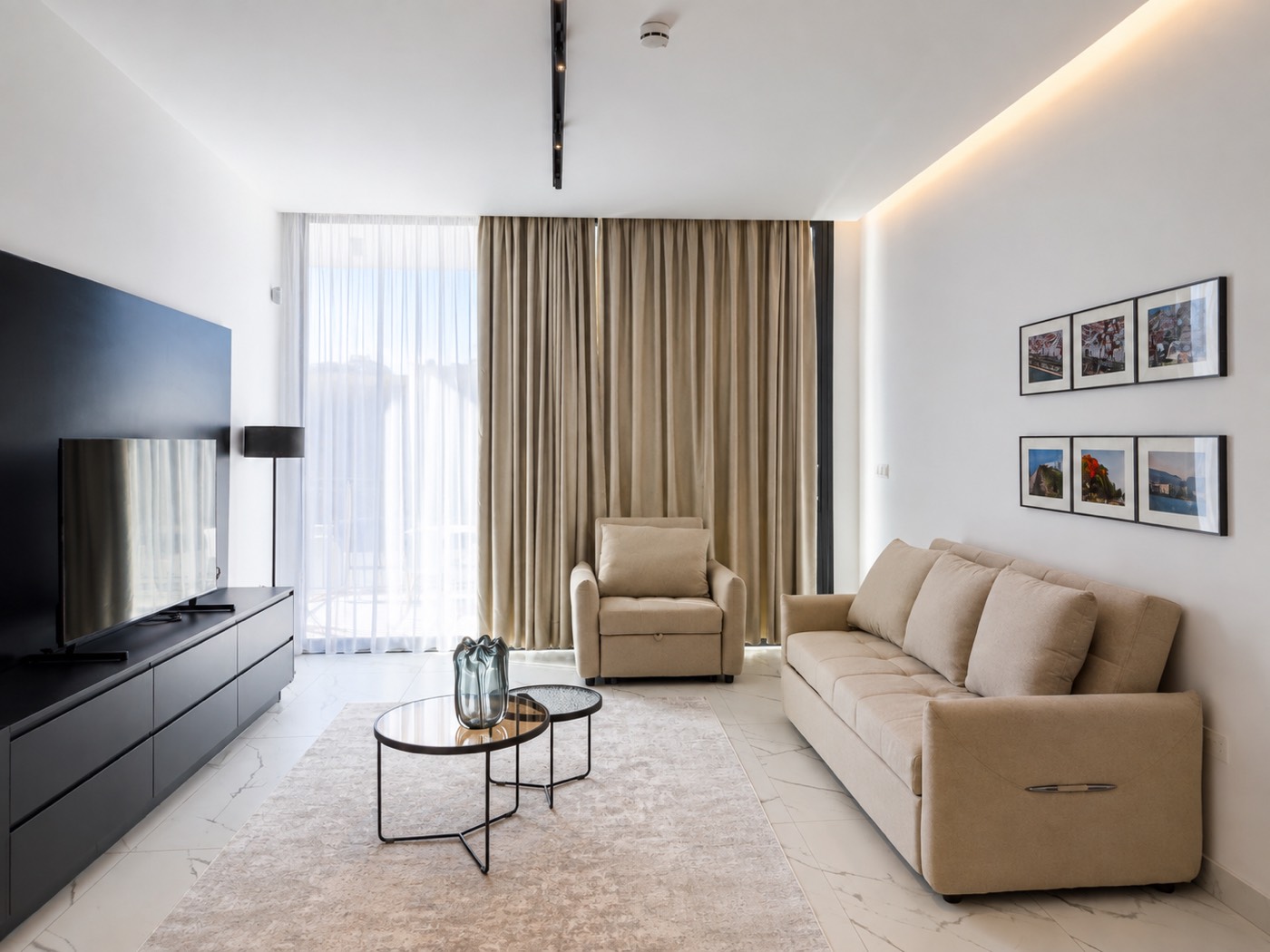 Living room with sofa, seating and balcony doors in a Swift Suites Limassol apartment